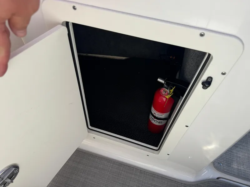 Slide: The Image of Storage compartment in 2020 Chaparral 21 SSi Ski & Fish OB with fire extinguisher. - 17
