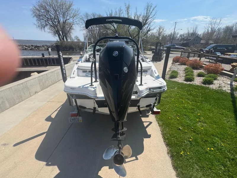 Slide: The Image of 2020 Chaparral 21 SSi Ski & Fish OB boat, rear view with outboard motor, parked on driveway. - 18