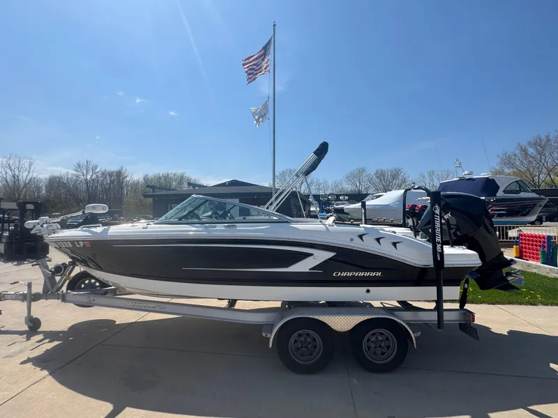 Slide: The Image of 2020 Chaparral 21 SSi Ski & Fish OB boat on trailer, parked outdoors under clear sky. - 3