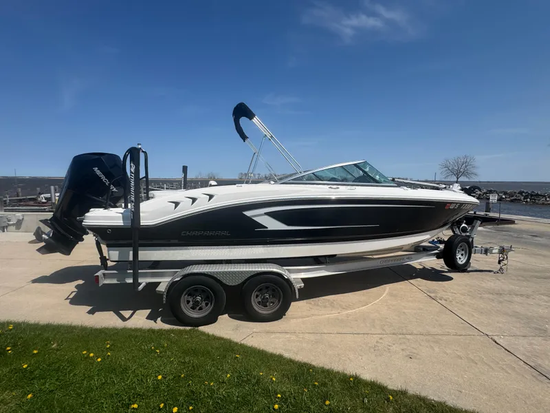 Slide: The Image of 2020 Chaparral 21 SSi Ski & Fish OB boat on trailer, parked outdoors under clear sky. - 5