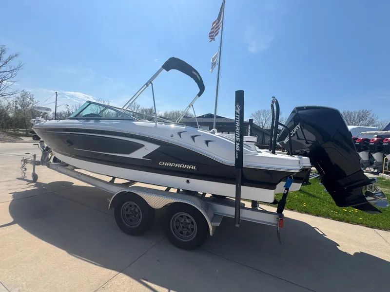 Slide: The Image of 2020 Chaparral 21 SSi Ski & Fish OB boat on trailer, parked outdoors. - 6