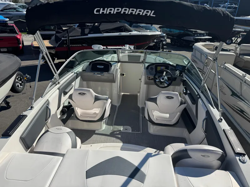 Slide: The Image of 2020 Chaparral 21 SSi Ski & Fish OB boat interior with seating and steering wheel. - 7