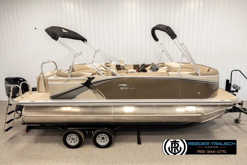 Slide: The Image of 2024 Tahoe 2185 LTZ QL pontoon boat with dual bimini tops on a trailer. - 1