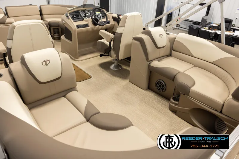 Slide: The Image of 2024 Tahoe 2185 LTZ QL boat interior with beige seating and modern dashboard. - 11