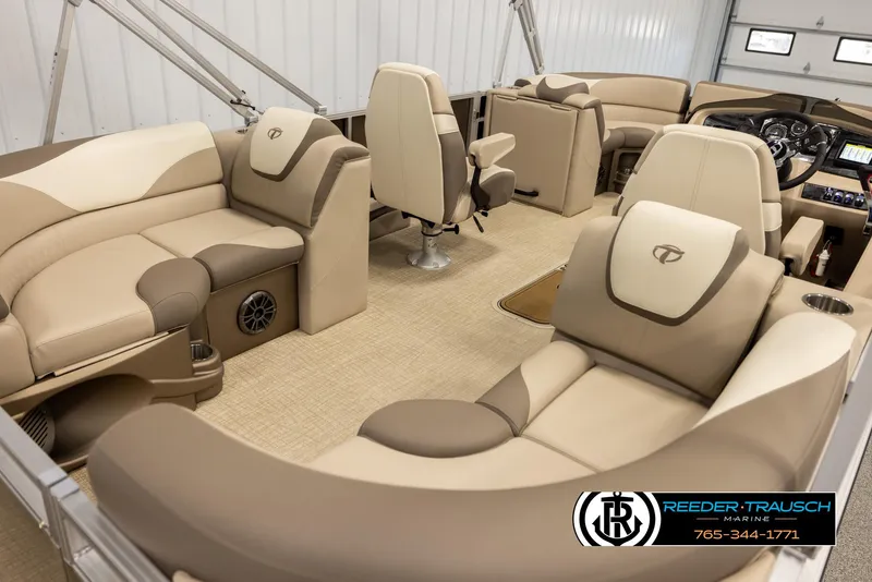 Slide: The Image of 2024 Tahoe 2185 LTZ QL boat interior with beige seating and modern dashboard. - 12