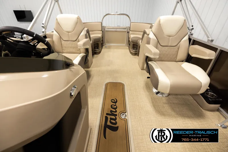 Slide: The Image of 2024 Tahoe 2185 LTZ QL boat interior with beige seating and wood accents. - 14