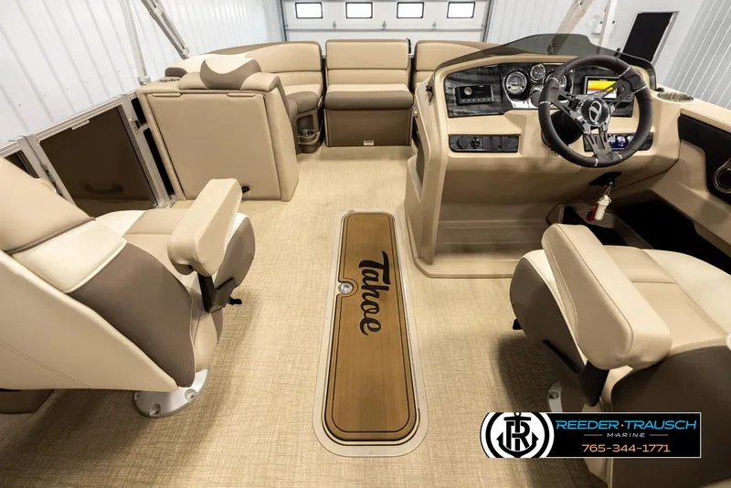 Slide: The Image of 2024 Tahoe 2185 LTZ QL boat interior with beige seating and modern dashboard. - 18