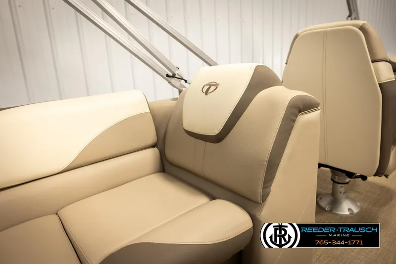 Slide: The Image of 2024 Tahoe 2185 LTZ QL boat interior with beige seating and logo. - 22