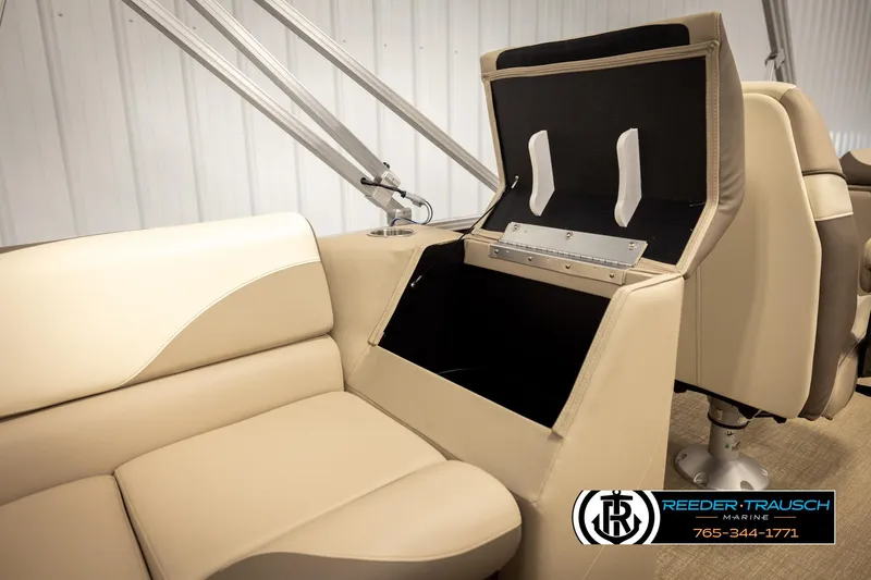 Slide: The Image of 2024 Tahoe 2185 LTZ QL boat interior with open storage compartment and beige seating. - 23