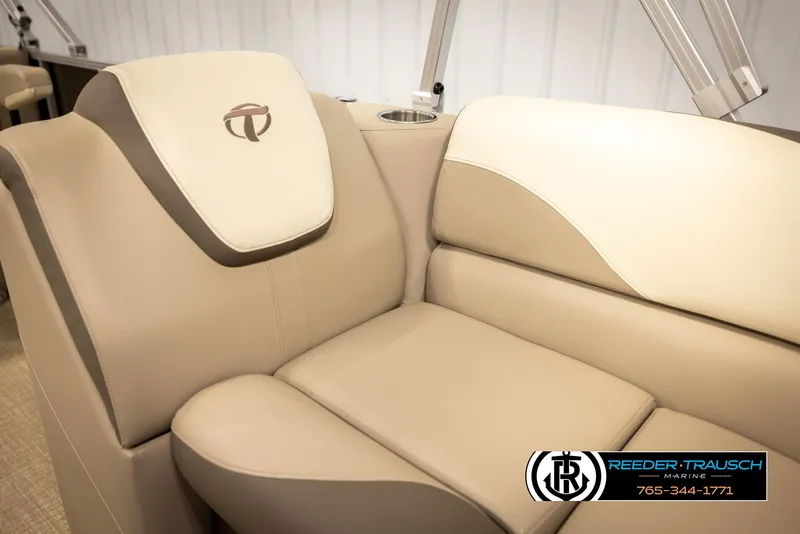 Slide: The Image of 2024 Tahoe 2185 LTZ QL boat interior with beige leather seating and logo. - 25