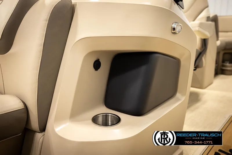 Slide: The Image of 2024 Tahoe 2185 LTZ QL interior detail with cup holder and storage compartment. - 27