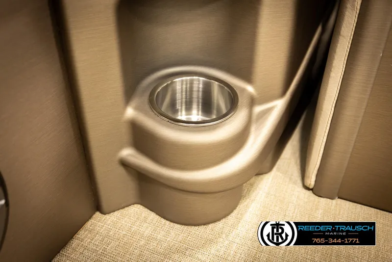 Slide: The Image of 2024 Tahoe 2185 LTZ QL cup holder detail with beige interior. - 28