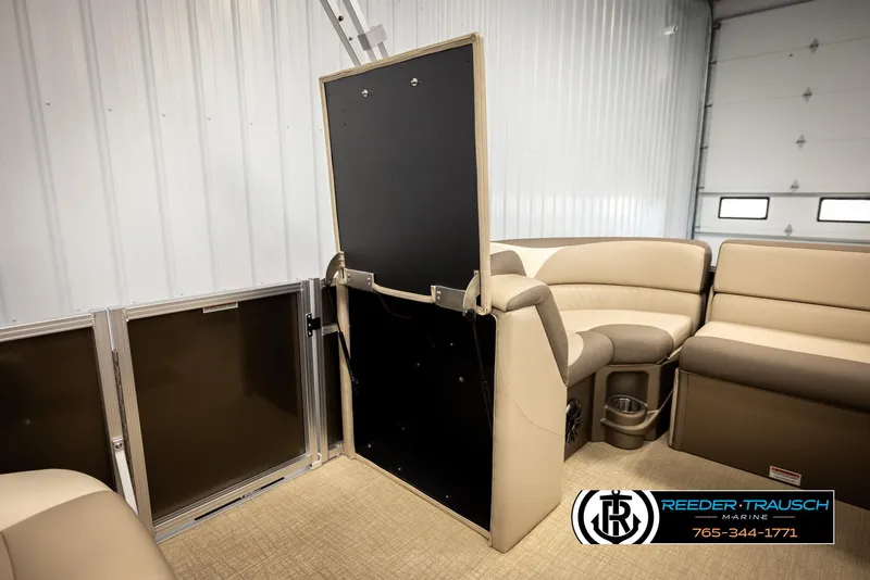 Slide: The Image of 2024 Tahoe 2185 LTZ QL boat interior with beige seating and storage compartment. - 32