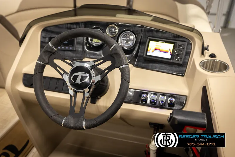 Slide: The Image of 2024 Tahoe 2185 LTZ QL boat dashboard with steering wheel and control panel. - 33