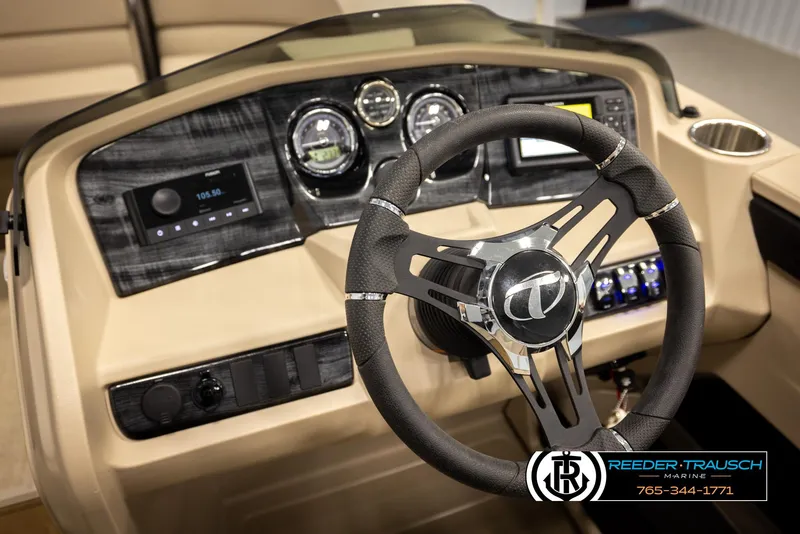 Slide: The Image of 2024 Tahoe 2185 LTZ QL boat dashboard with steering wheel and control panel. - 34