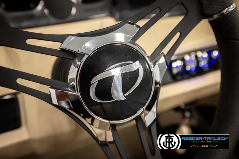 Slide: The Image of Steering wheel of 2024 Tahoe 2185 LTZ QL boat, featuring sleek design and logo. - 35