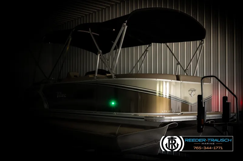Slide: The Image of 2024 Tahoe 2185 LTZ QL pontoon boat in dimly lit storage facility. - 4