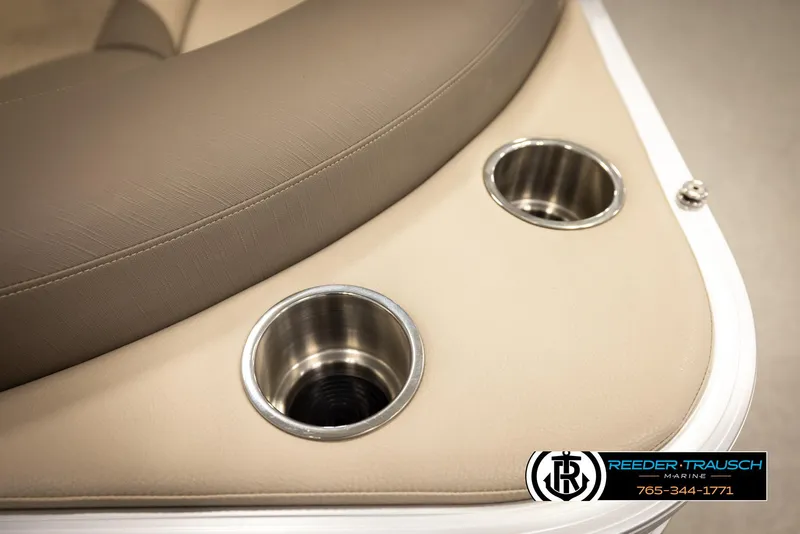 Slide: The Image of 2024 Tahoe 2185 LTZ QL boat interior with beige seating and stainless steel cup holders. - 43