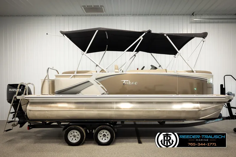 Slide: The Image of 2024 Tahoe 2185 LTZ QL pontoon boat with canopy on trailer in showroom. - 5