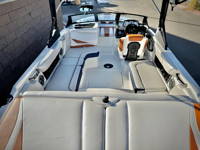 Slide: The Image of 2021 Axis T22 boat interior with white and orange seating, sleek design, and modern dashboard. - 11