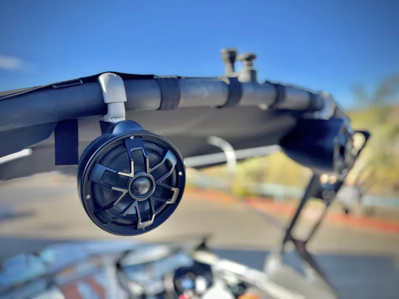 Slide: The Image of 2021 Axis T22 boat with mounted speakers on a sunny day. - 13