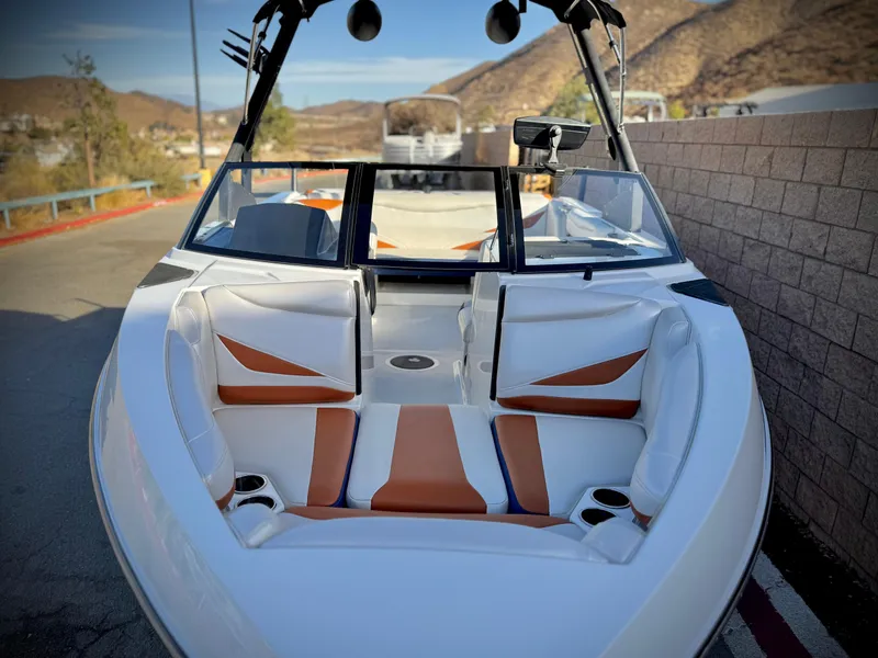 Slide: The Image of 2021 Axis T22 boat with sleek seating, docked near mountains. - 15