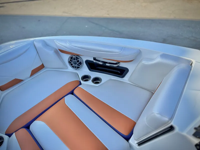 Slide: The Image of Interior of 2021 Axis T22 boat with tan and white seating, cup holders, and speaker. - 18
