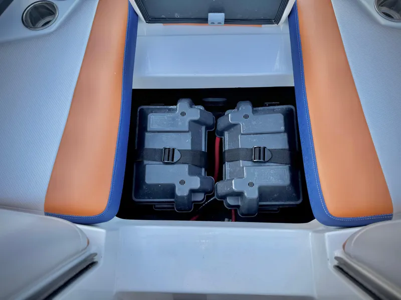 Slide: The Image of 2021 Axis T22 boat interior with dual battery compartments and orange seating. - 19