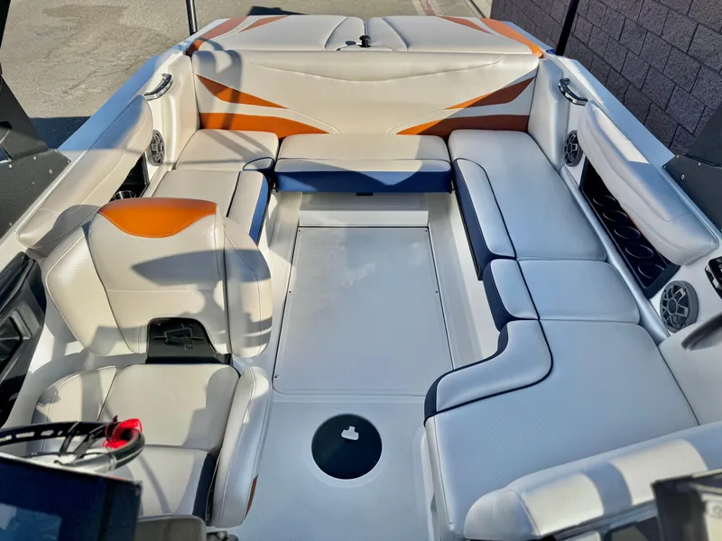 Slide: The Image of 2021 Axis T22 boat interior with white and orange seating, spacious layout. - 20