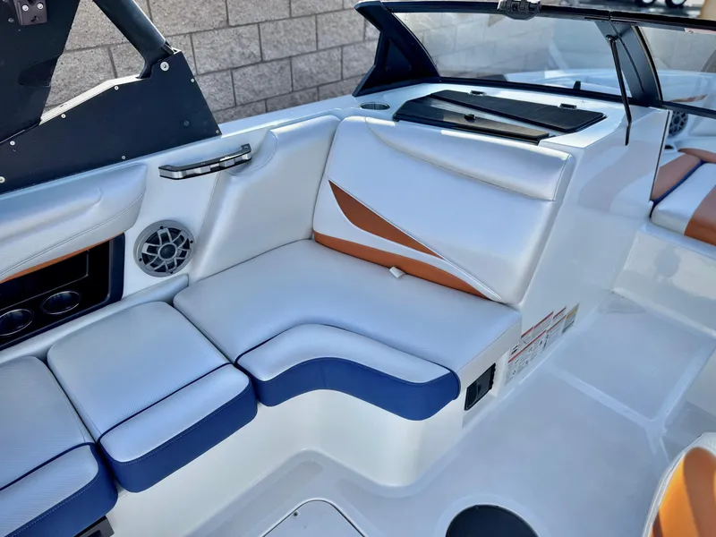 Slide: The Image of 2021 Axis T22 boat interior with white and blue seating, speaker, and modern design. - 21