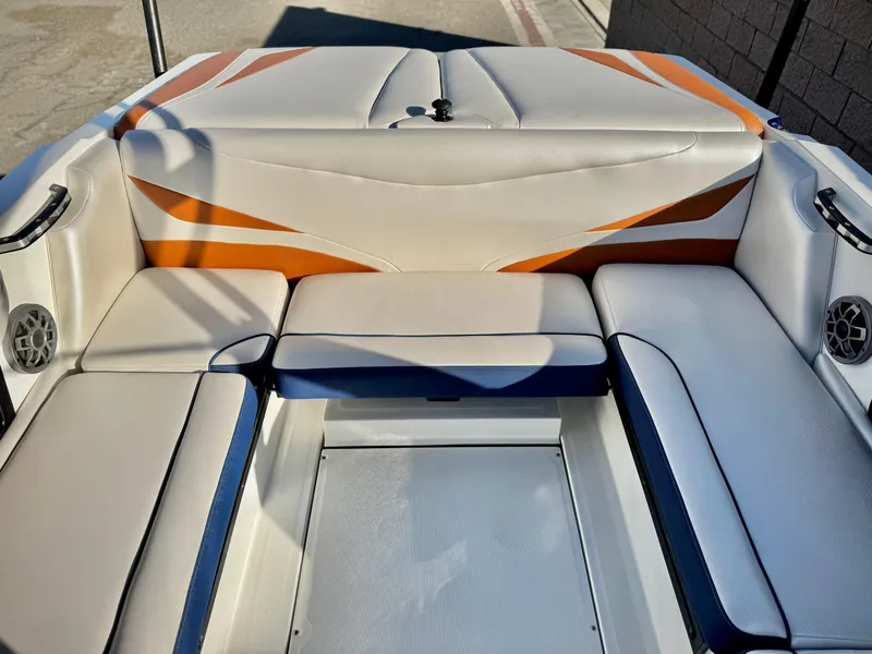 Slide: The Image of 2021 Axis T22 boat interior with orange and white seating, featuring built-in speakers. - 22