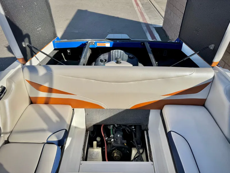 Slide: The Image of 2021 Axis T22 boat interior with engine compartment open, showcasing seating and upholstery design. - 23