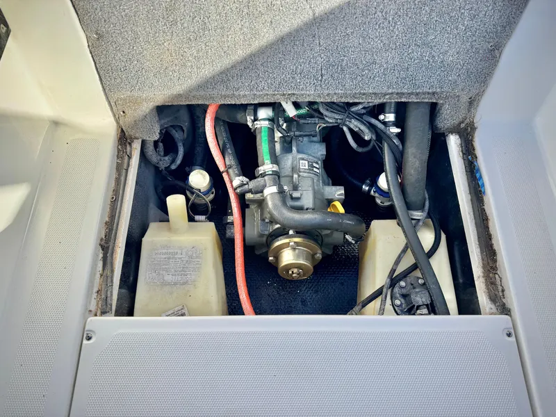 Slide: The Image of Engine compartment of a 2021 Axis T22 boat, showing mechanical components and wiring. - 24