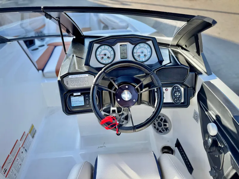 Slide: The Image of 2021 Axis T22 boat dashboard with steering wheel and gauges. - 30