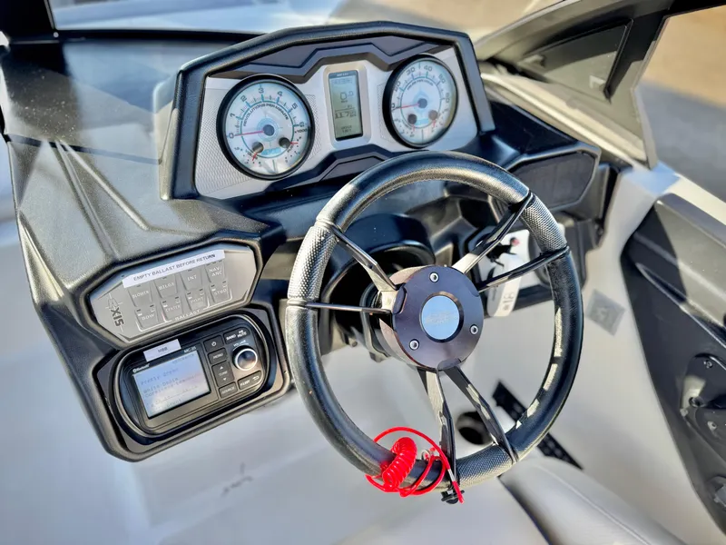 Slide: The Image of Steering wheel and dashboard of 2021 Axis T22 boat with gauges and controls. - 31