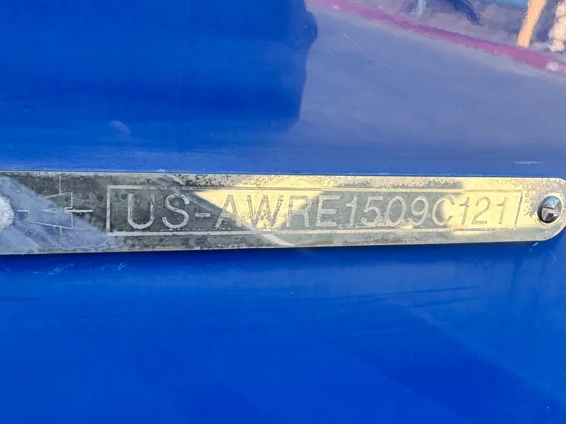 Slide: The Image of Metallic identification plate on blue Axis T22, 2021 model. - 34