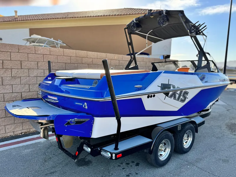 Slide: The Image of 2021 Axis T22 boat with blue and white design on a trailer. - 5