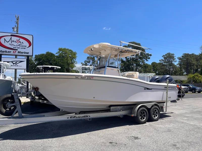Slide: The Image of 2013 Grady-White Fisherman 257 boat on trailer at dealership under clear blue sky. - 1