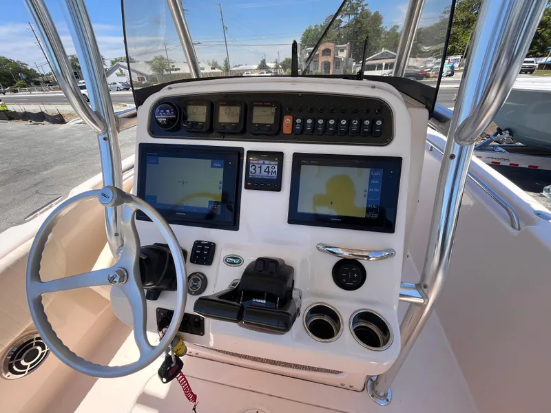 Slide: The Image of 2013 Grady-White Fisherman 257 boat dashboard with navigation screens and controls. - 12