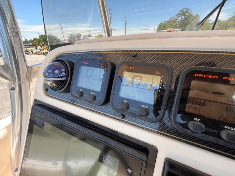 Slide: The Image of Dashboard of 2013 Grady-White Fisherman 257 boat with navigation instruments and gauges. - 13