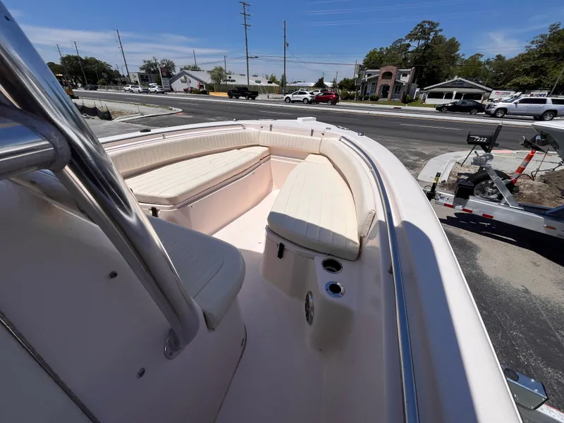 Slide: The Image of 2013 Grady-White Fisherman 257 boat with cushioned seating, parked on a trailer. - 15