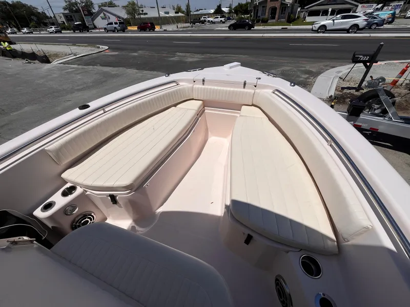 Slide: The Image of 2013 Grady-White Fisherman 257 boat interior with cushioned seating and cup holders. - 16
