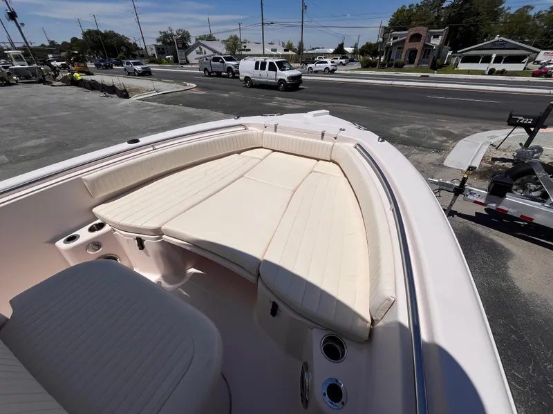 Slide: The Image of 2013 Grady-White Fisherman 257 boat with spacious seating, parked near a road. - 17