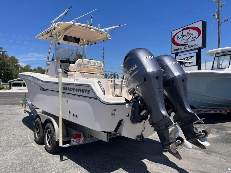Slide: The Image of 2013 Grady-White Fisherman 257 boat with twin Yamaha engines on a trailer. - 2