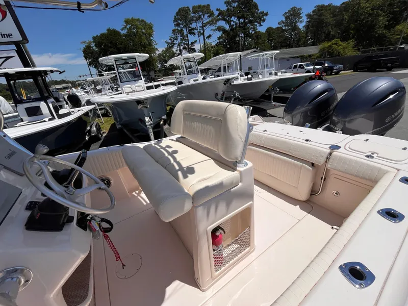 Slide: The Image of 2013 Grady-White Fisherman 257 boat interior with seating and dual outboard motors. - 21