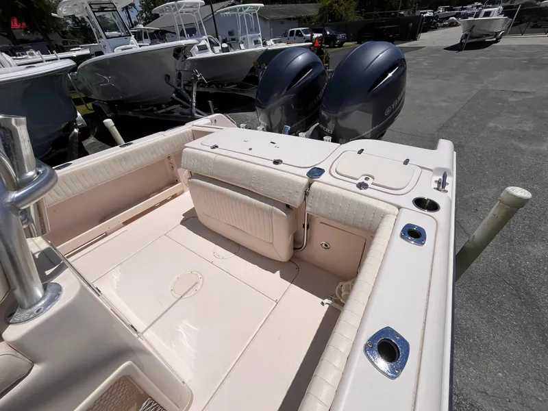 Slide: The Image of 2013 Grady-White Fisherman 257 boat with dual outboard motors, docked in a marina. - 22