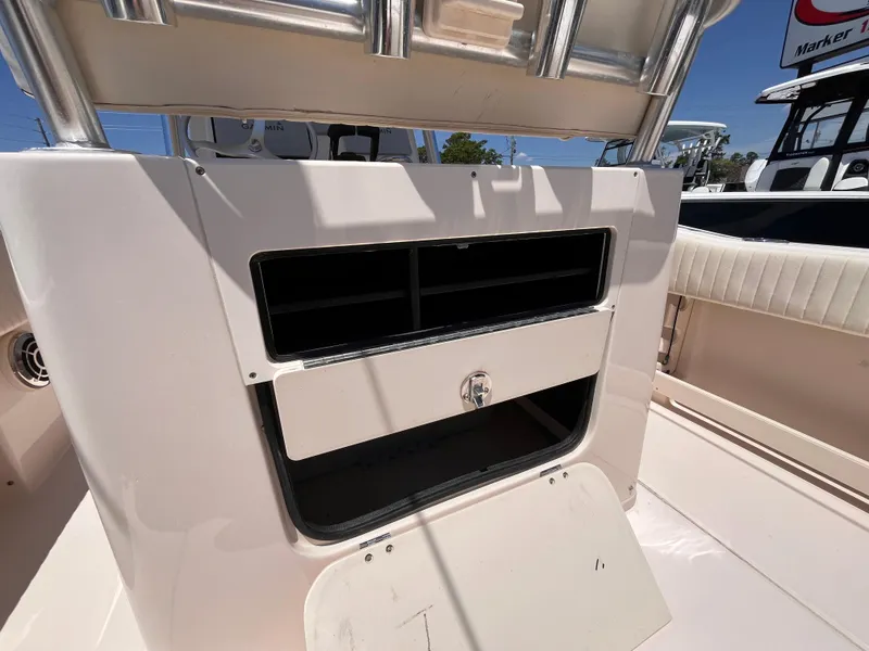 Slide: The Image of 2013 Grady-White Fisherman 257 boat storage compartment with open hatch, showcasing interior space. - 24
