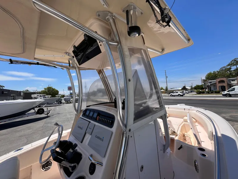 Slide: The Image of 2013 Grady-White Fisherman 257 boat console with steering wheel and navigation equipment. - 25