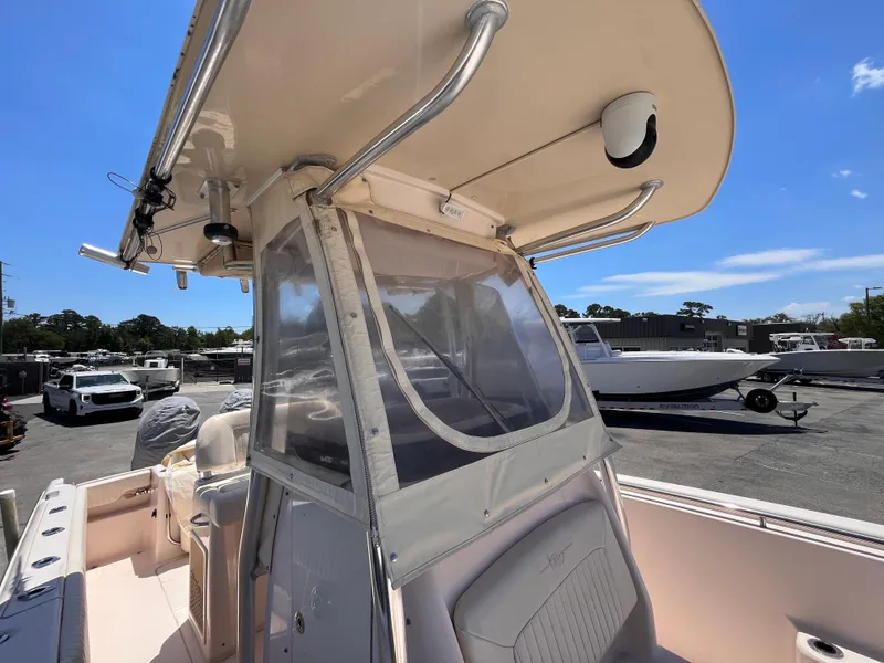 Slide: The Image of 2013 Grady-White Fisherman 257 boat with T-top and clear enclosure, parked outdoors. - 26