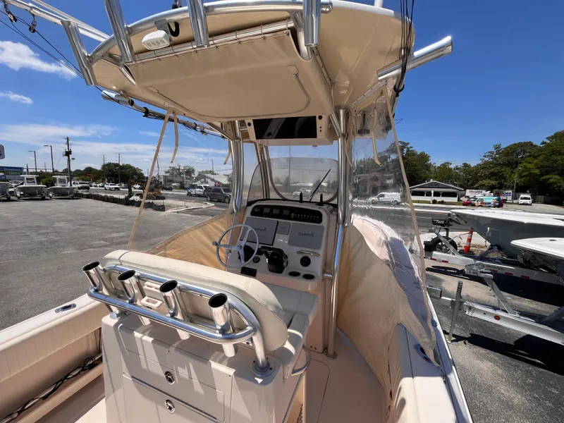 Slide: The Image of 2013 Grady-White Fisherman 257 boat with center console and T-top in a marina setting. - 27